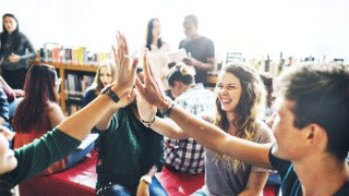 Students giving high fives